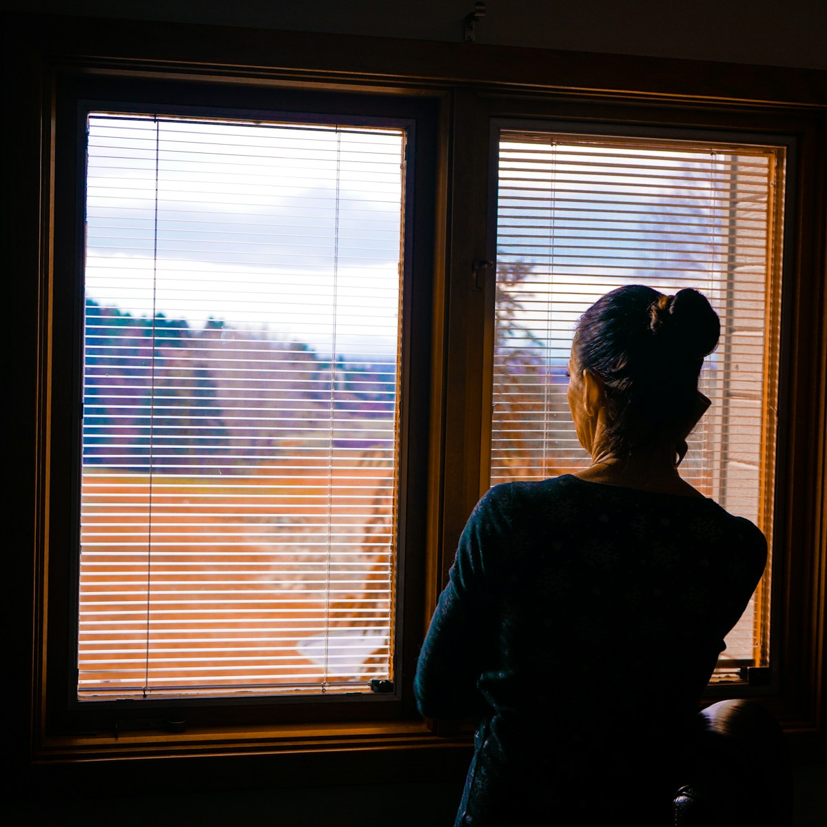 woman standing front of window